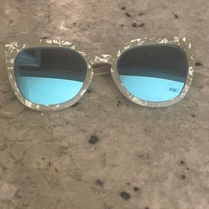 Quay, blue mirrored cat eye frames; white pearl frames
